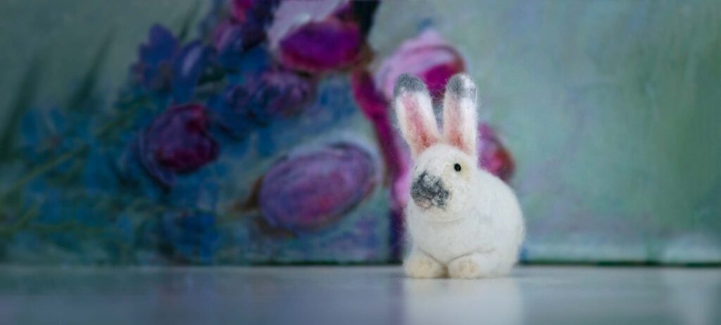 white needle-felted rabbit with grey nose
